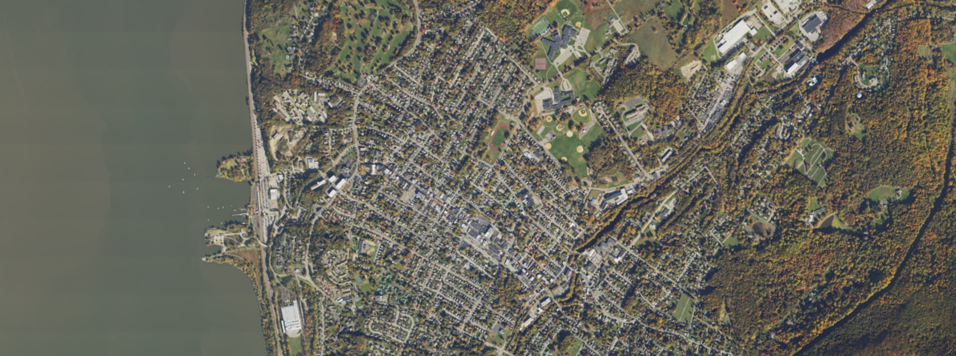 Aerial survey view over Beacon, NY, showing the road network, tree cover and surrounding countryside