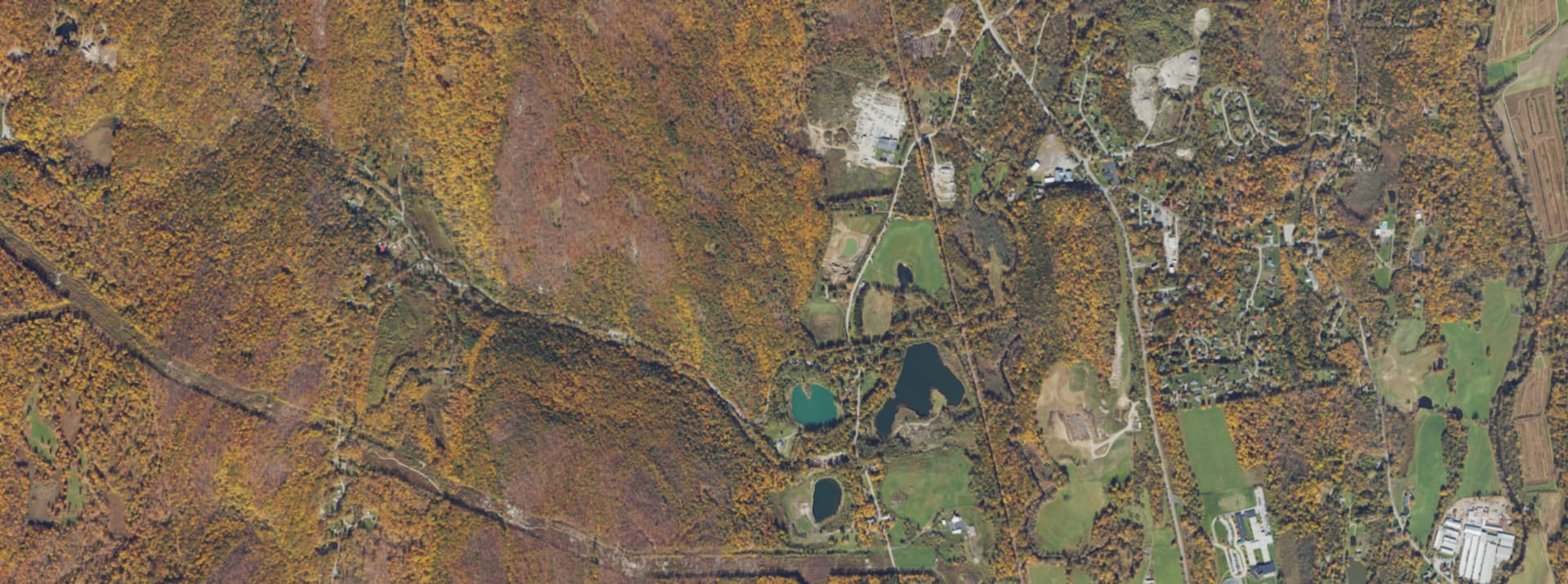 Aerial survey view over Dover Plains, NY, showing the Ten Mile River valley, rail line and wooded hillsides