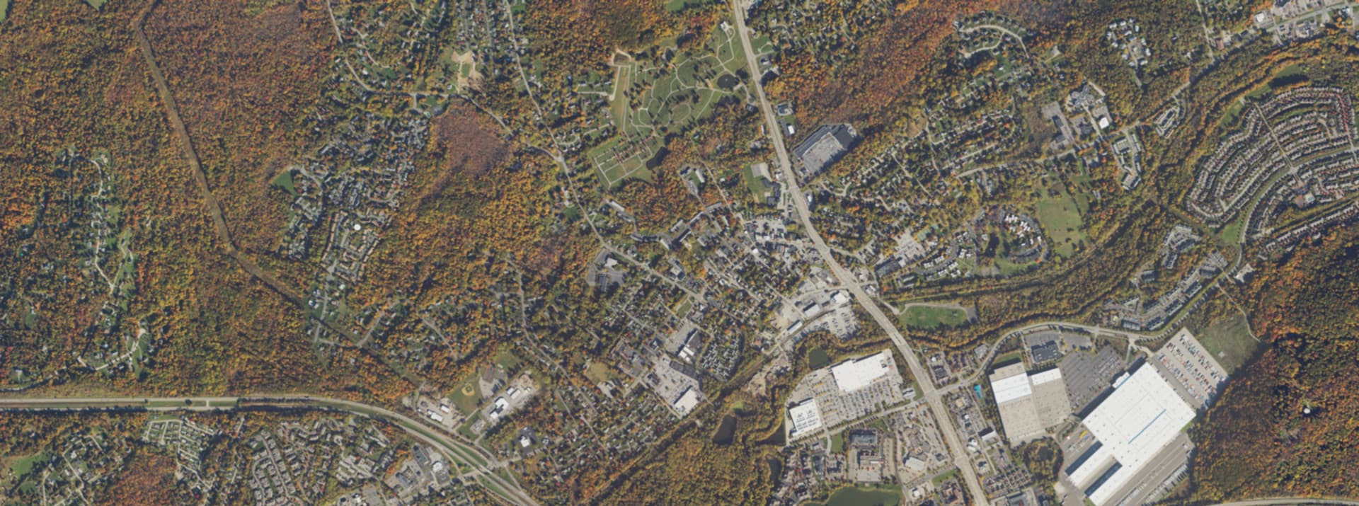 Aerial view over the centre of Fishkill, NY — the white church steeple, Main Street and the hills beyond