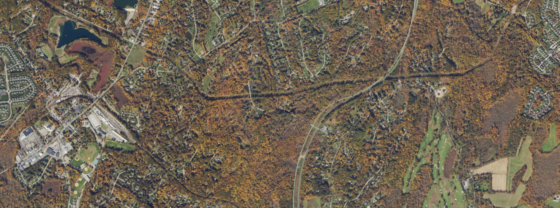 Aerial survey view over Hopewell Junction, NY, showing the road network, tree cover and surrounding countryside
