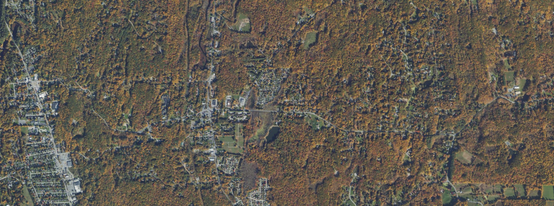 Aerial survey view over Hyde Park, NY, showing the road network, tree cover and surrounding countryside