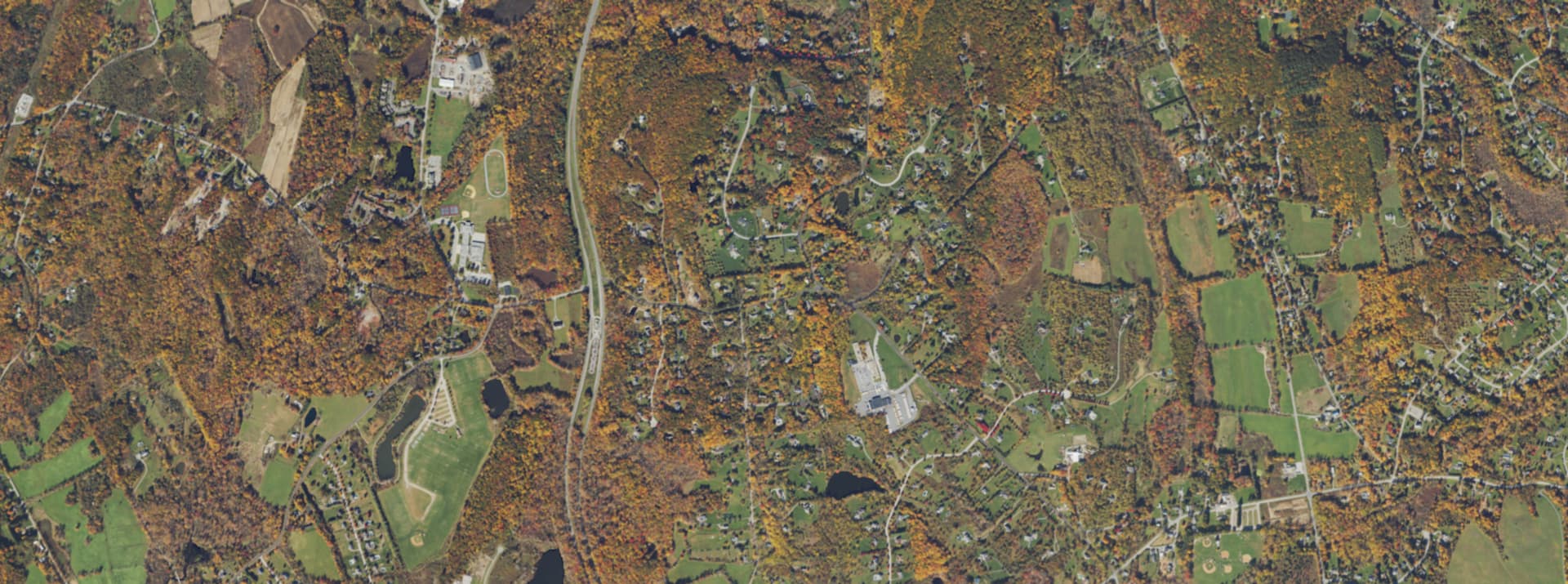 Aerial survey view over LaGrangeville, NY, showing the road network, tree cover and surrounding countryside