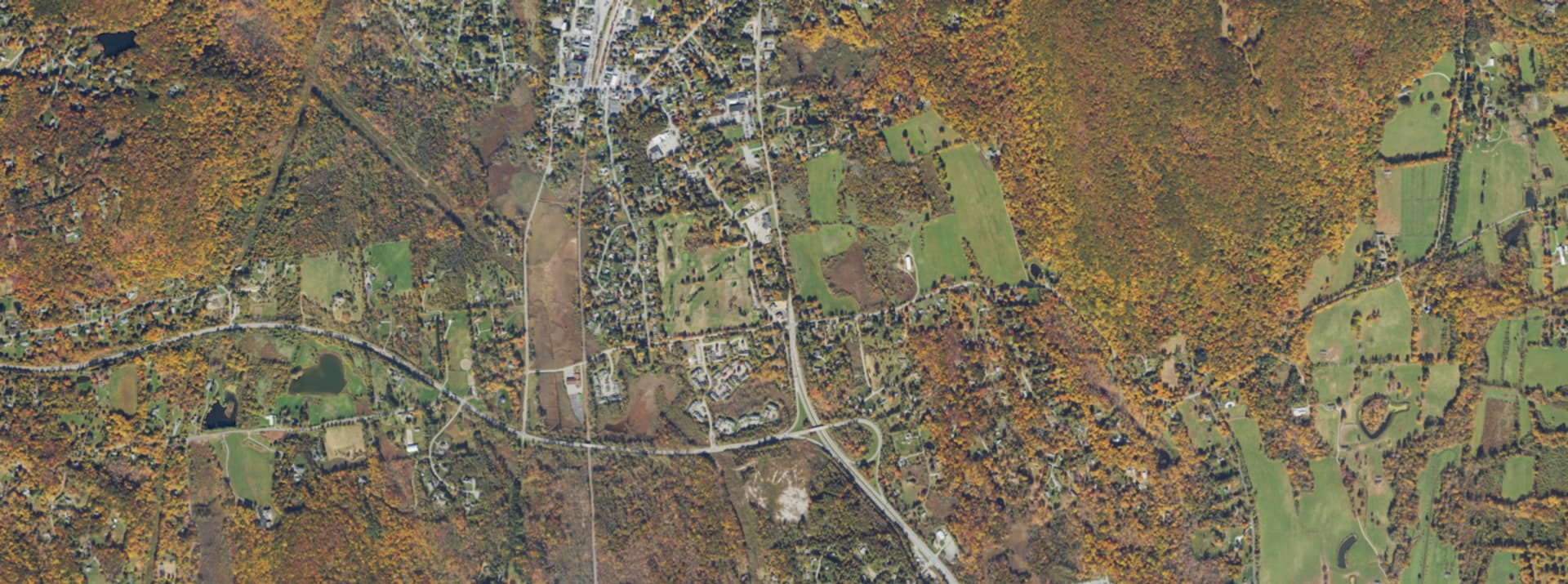 Aerial survey view over Pawling, NY, showing the road network, tree cover and surrounding countryside