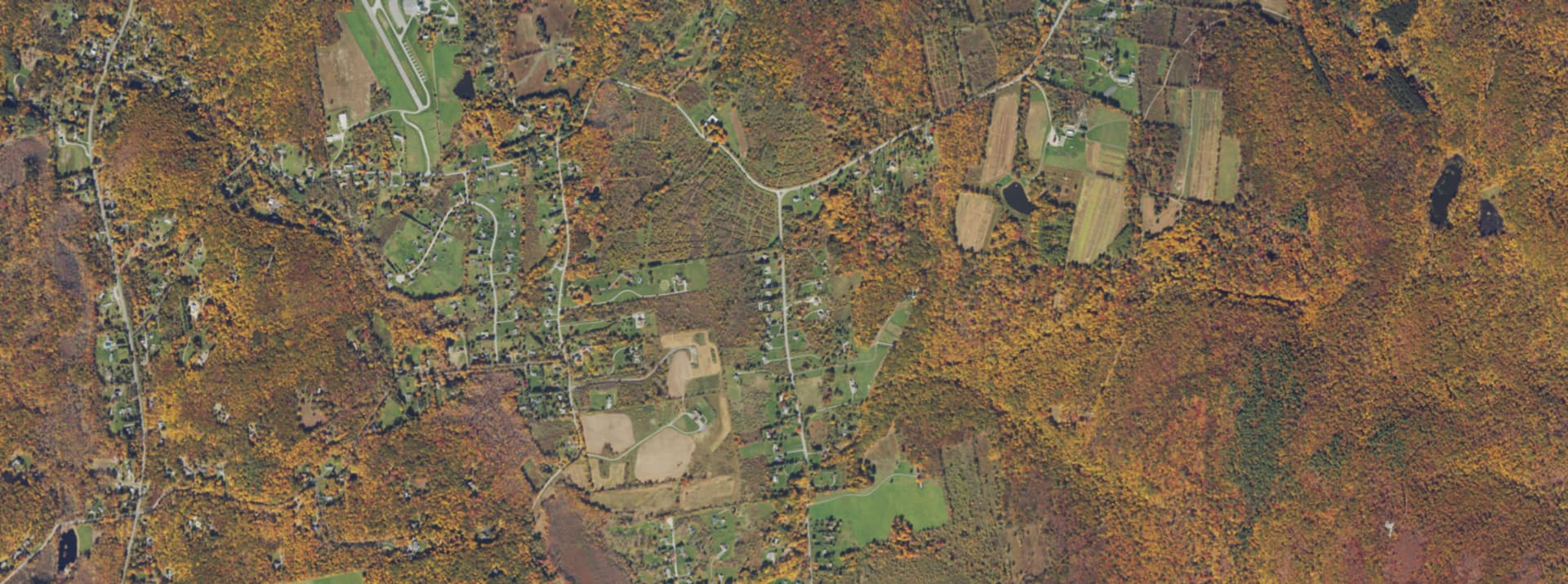 Aerial survey view over Union Vale, NY, showing open farmland, back roads and wooded ridgelines