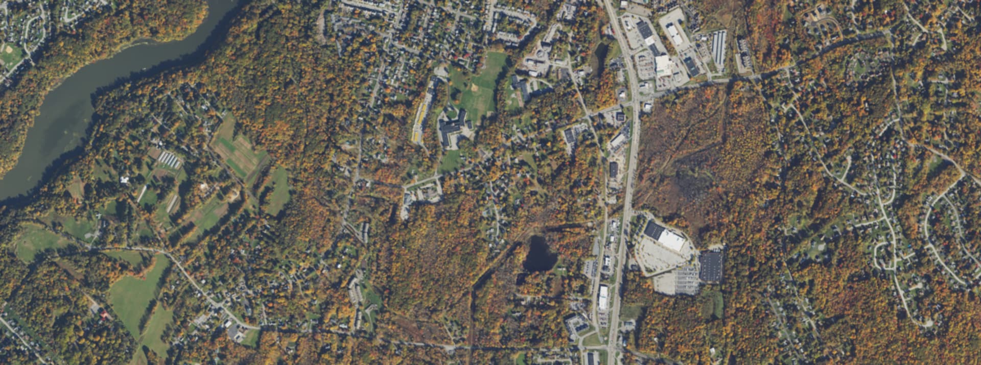 Aerial survey view over Wappinger, NY, showing the Route 9 corridor, Wappinger Lake and surrounding tree cover